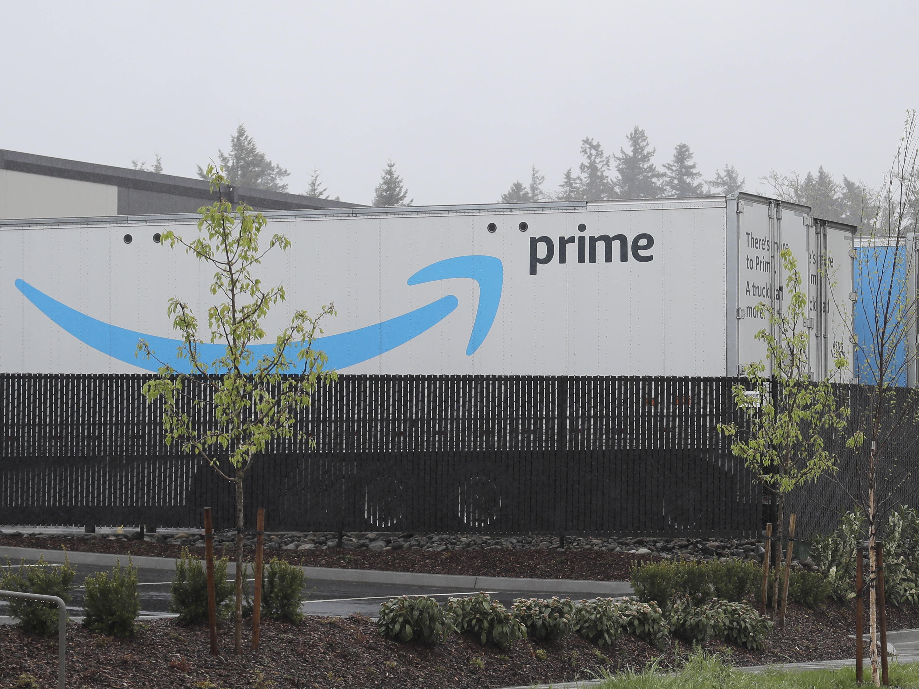 The Amazon Prime logo is shown on a truck trailer parked at a fulfillment center in Washington.