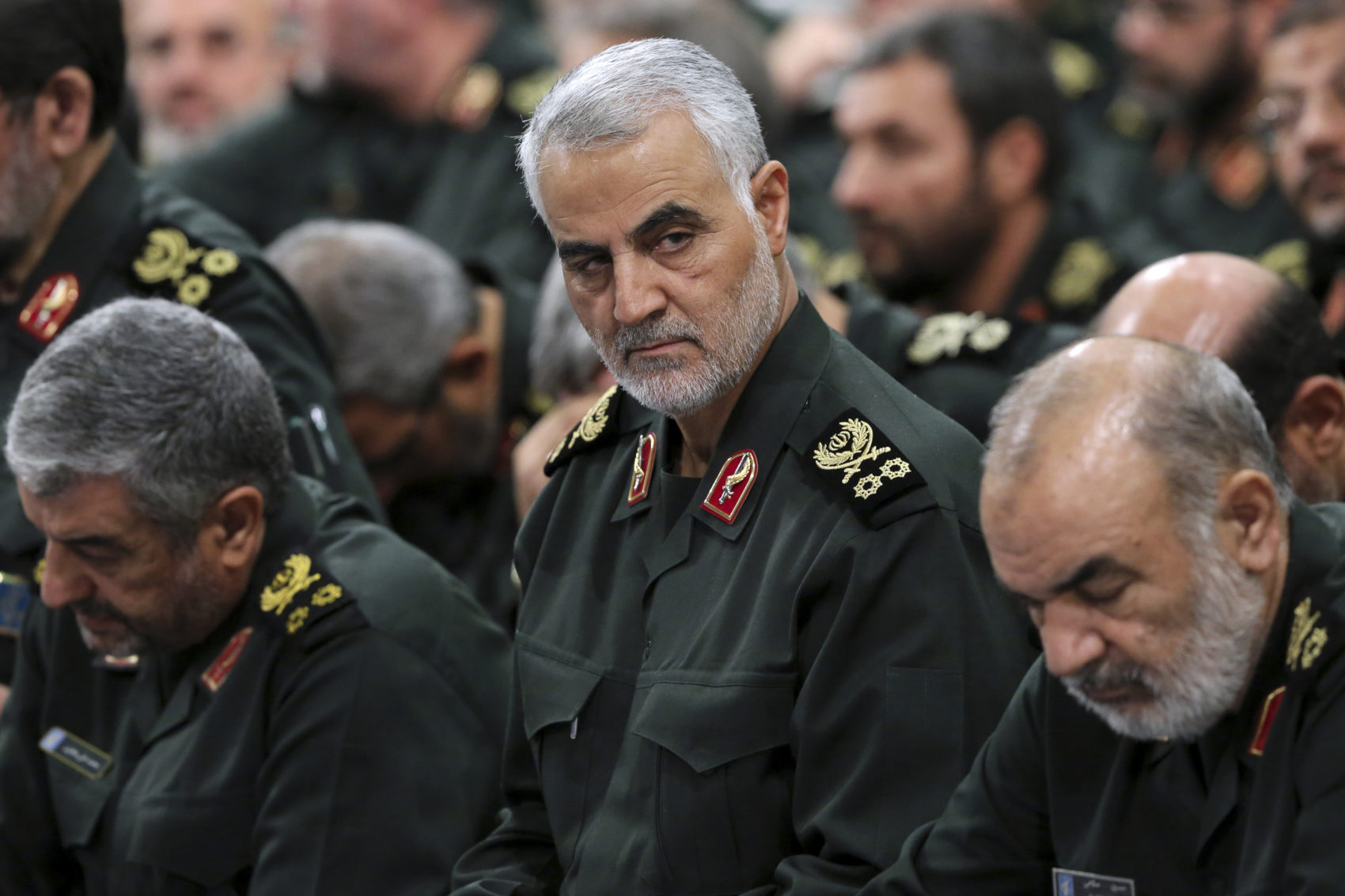 caption: In this Sept. 18, 2016, file photo provided by an official website of the office of the Iranian supreme leader, Revolutionary Guard Gen. Qassem Soleimani, center, attends a meeting in Tehran, Iran. (Office of the Iranian Supreme Leader via AP, File)