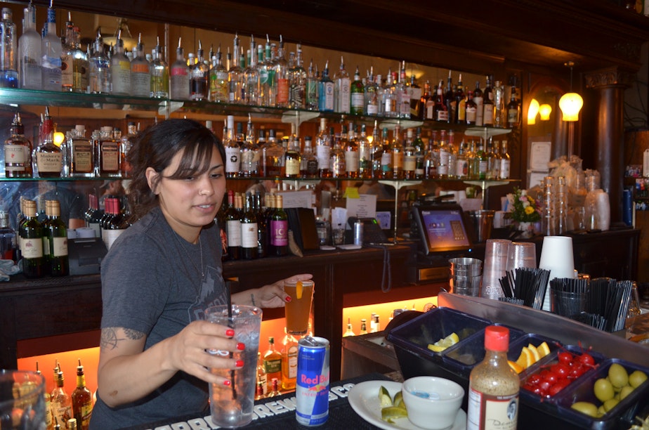 caption: Rita Rosa works at her newly reopened bar at the Rainier Bar and Grill in Enumclaw.