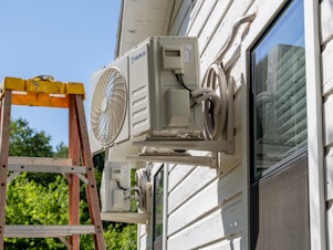 caption: An air conditioner undergoes repair earlier this month in Austin, Texas. Record-breaking temperatures continue across large swaths of the U.S.