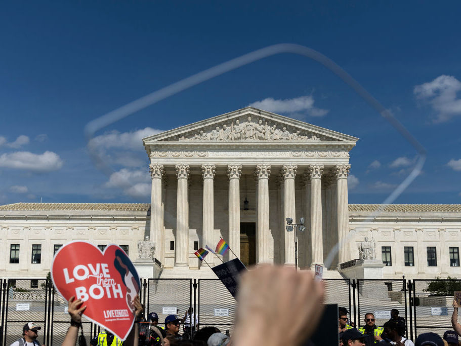 caption: Abortion-rights protesters and anti-abortion protesters gather Sunday outside the U.S. Supreme Court in Washington.
