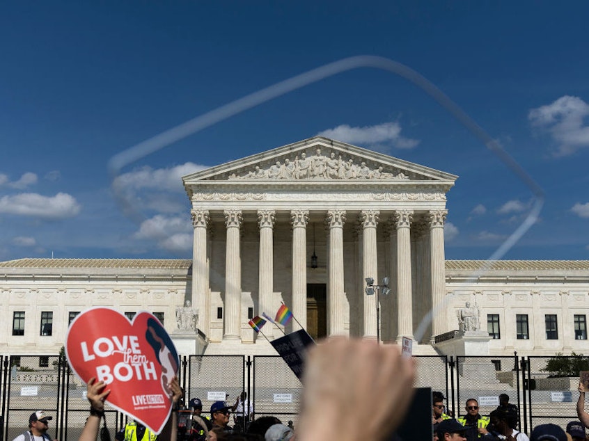 caption: Abortion-rights protesters and anti-abortion protesters gather Sunday outside the U.S. Supreme Court in Washington.