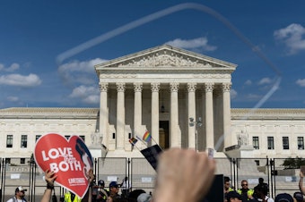 caption: Abortion-rights protesters and anti-abortion protesters gather Sunday outside the U.S. Supreme Court in Washington.