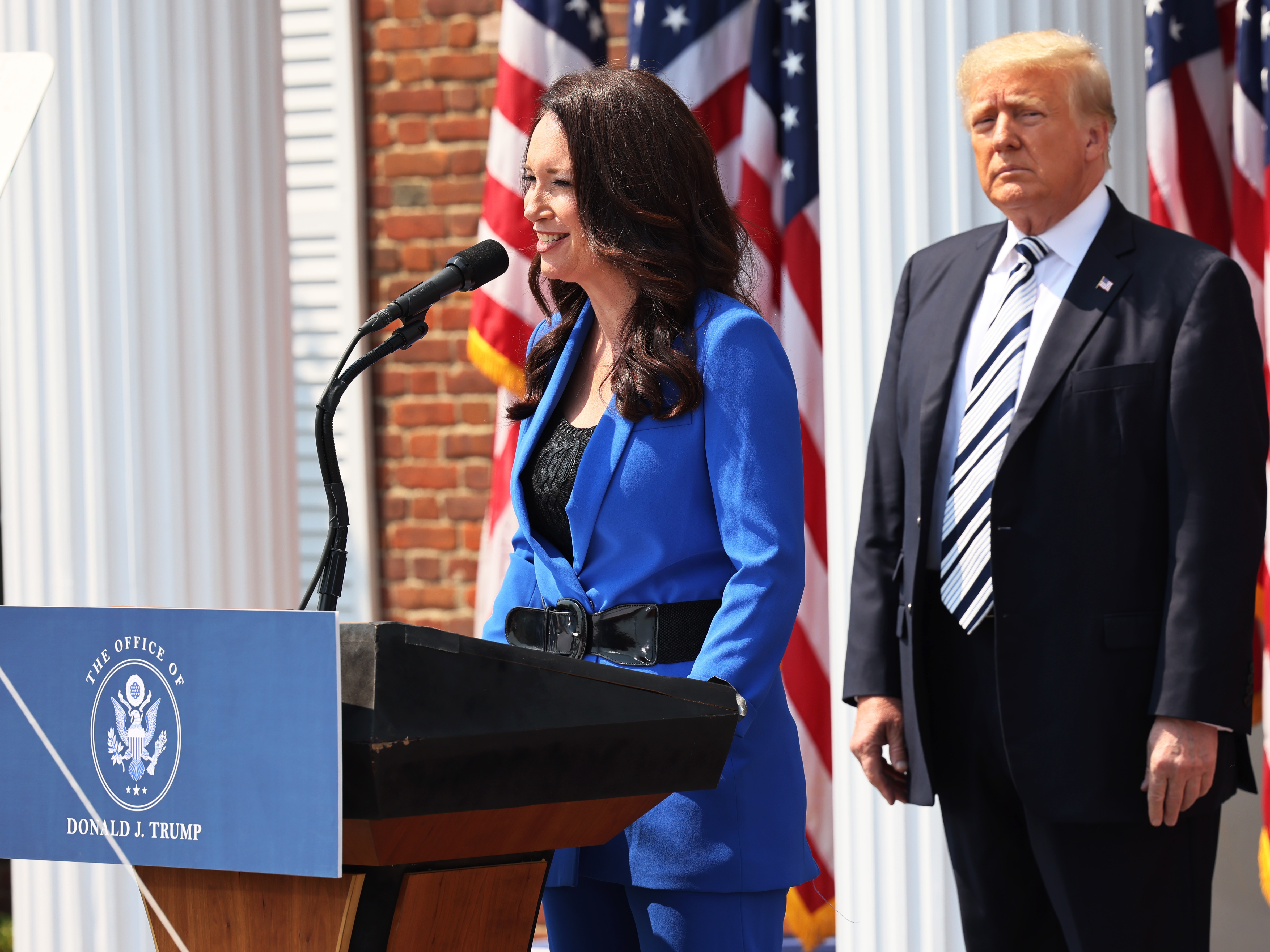 caption: Brooke Rollins, president and CEO of America First Policy Institute, introduces former President Donald Trump during a press conference in July 2021 in Bedminster, N.J.