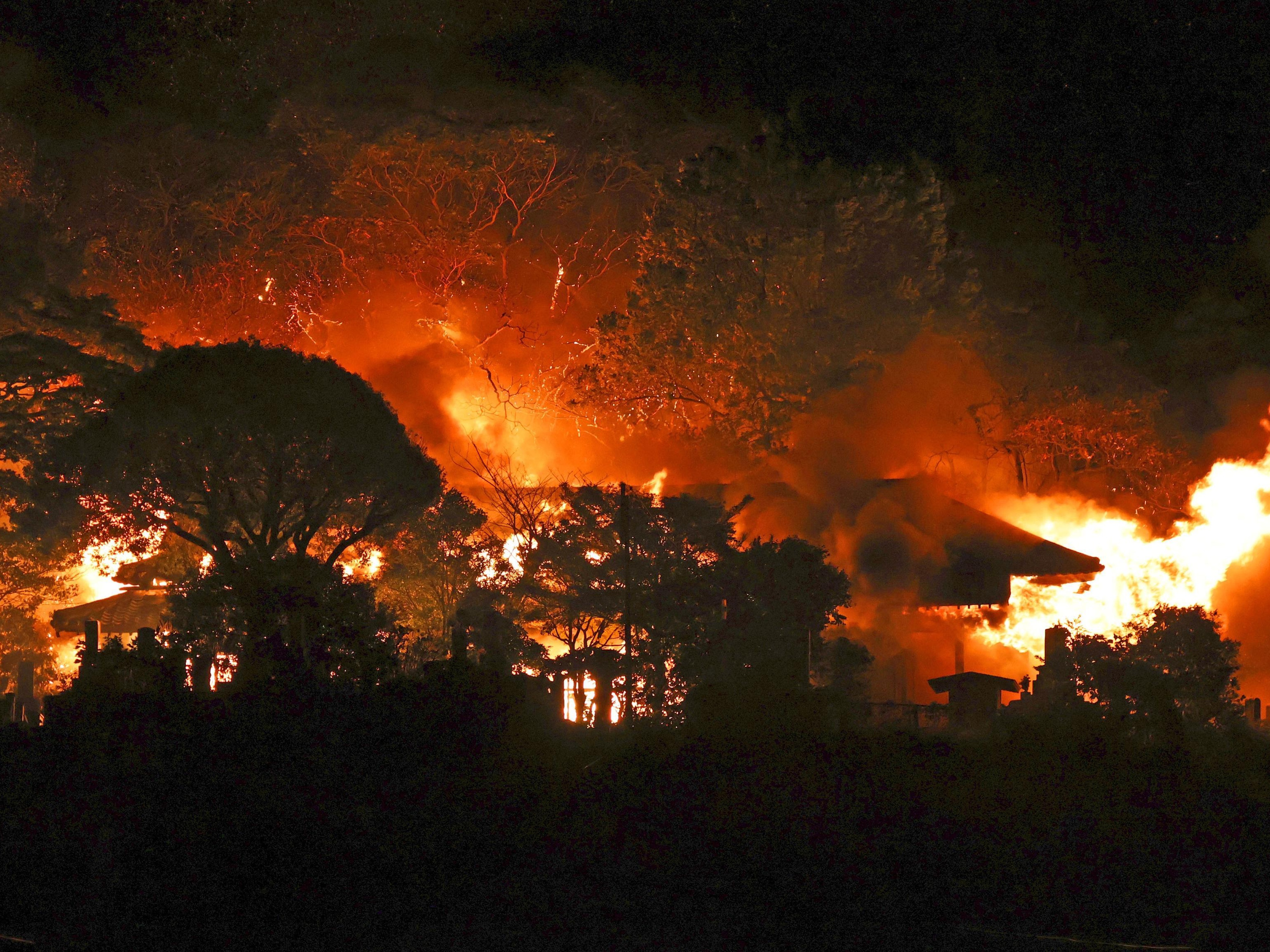 caption: Smoke rises over buildings after a fire in Oita, southern Japan, Wednesday.