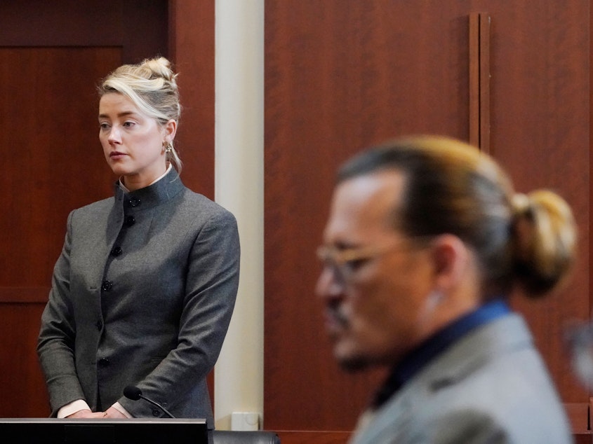 caption: Actors Amber Heard and Johnny Depp watch as the jury leaves the courtroom at the Fairfax County Circuit Courthouse in Fairfax, Va., on May 16. Depp sued Heard, his ex-wife, for libel after she wrote an op-ed piece in <em>The Washington Post</em> in 2018 titled,  "I spoke up against sexual violence — and faced our culture's wrath. That has to change."