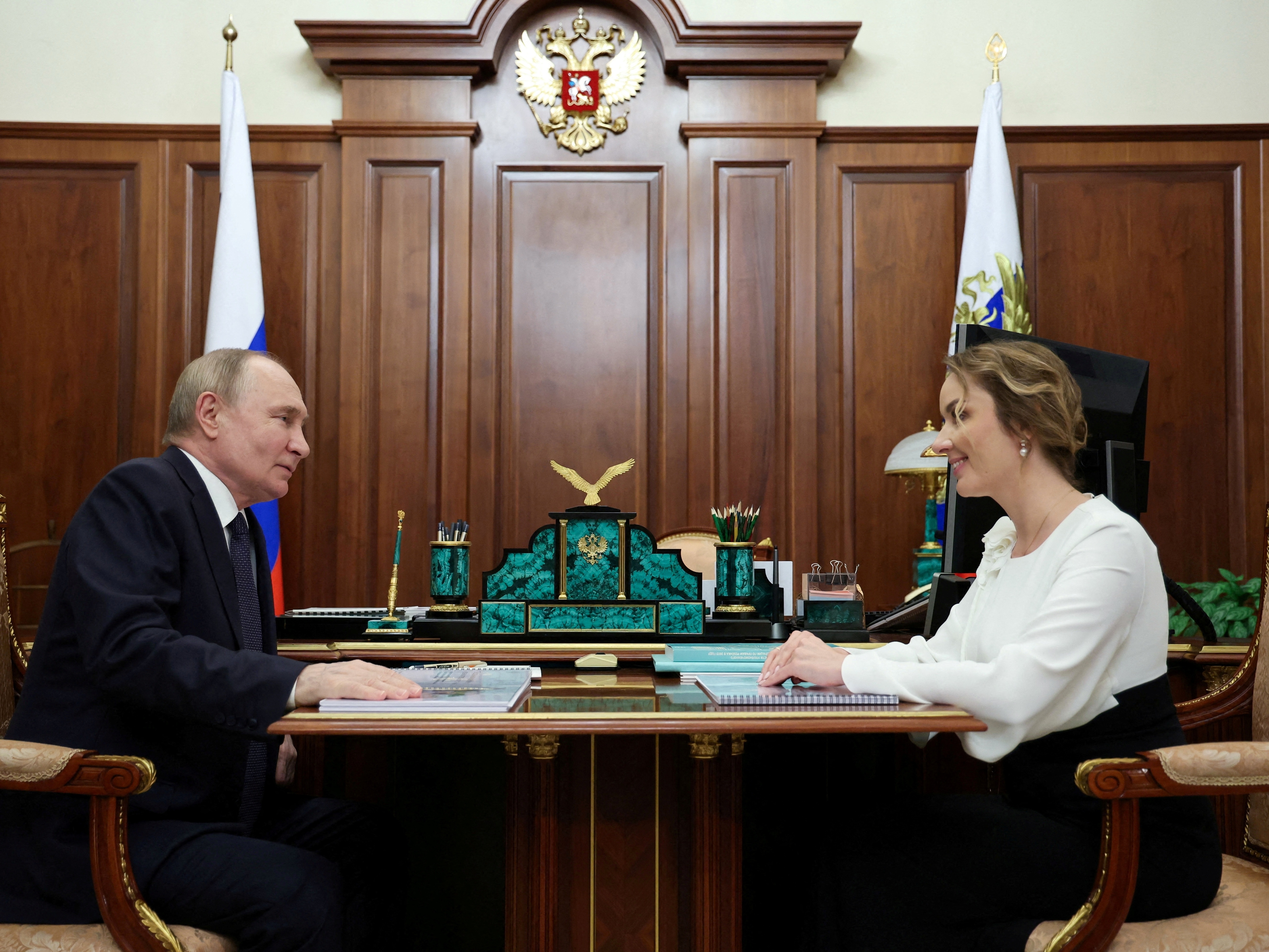 caption: Russian President Vladimir Putin meets with Presidential Commissioner for Children's Rights Maria Lvova-Belova in Moscow, May 31.