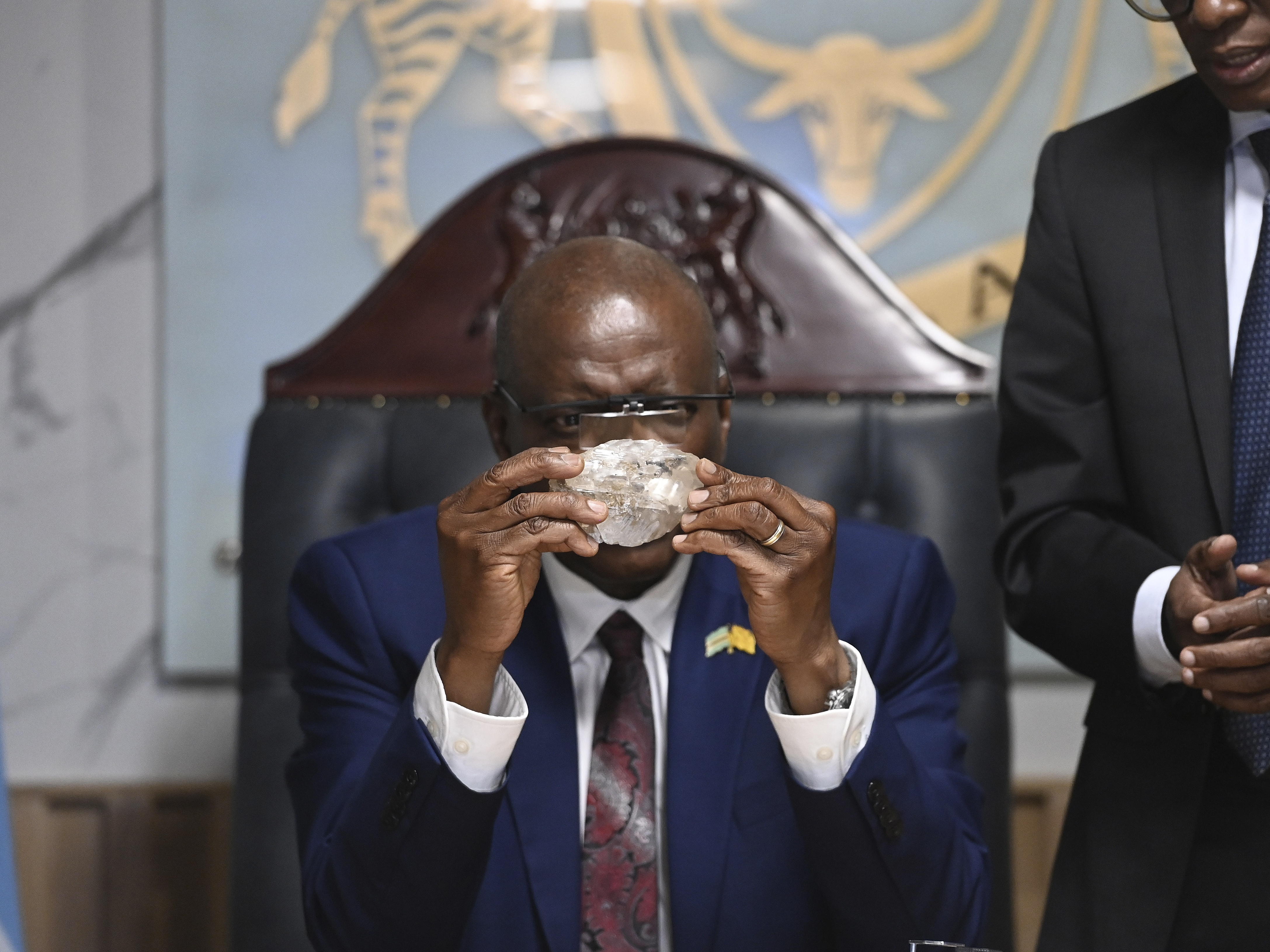 caption: Botswana's President Mokgweetsi Masisi holds the 2,492-carat diamond that was unearthed at one of its mines and will be put on show, on Thursday, Aug. 22, 2024, in Gaborone.