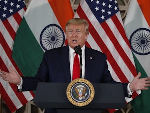 caption: President Trump speaks Tuesday with business leaders in New Delhi.