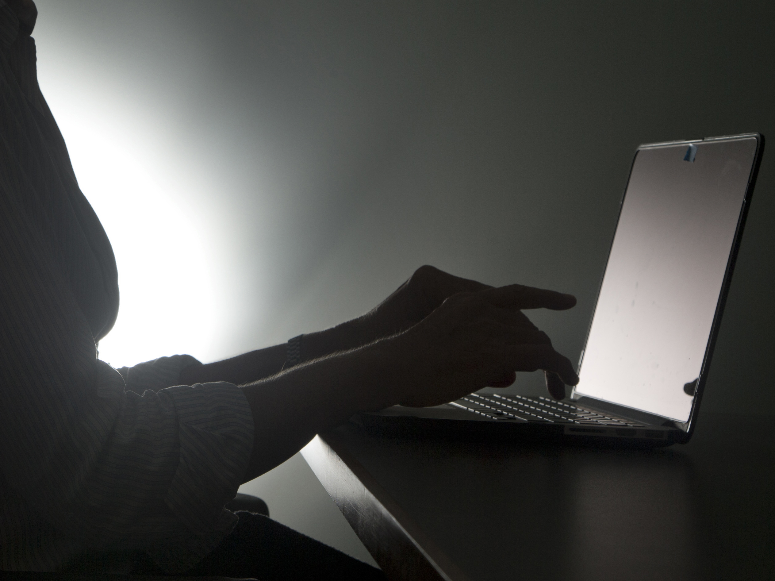 caption: Many tech workers say they have experienced more harassment, hostility and anxiety while working remotely during the pandemic.