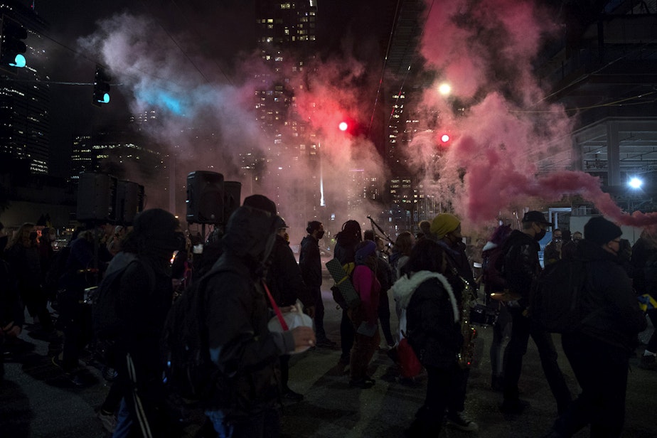 caption: A large crowd of demonstrators march from Cal Anderson Park to Westlake Park on Monday, October 26, 2020, during the 150th day of protests for racial justice in Seattle.