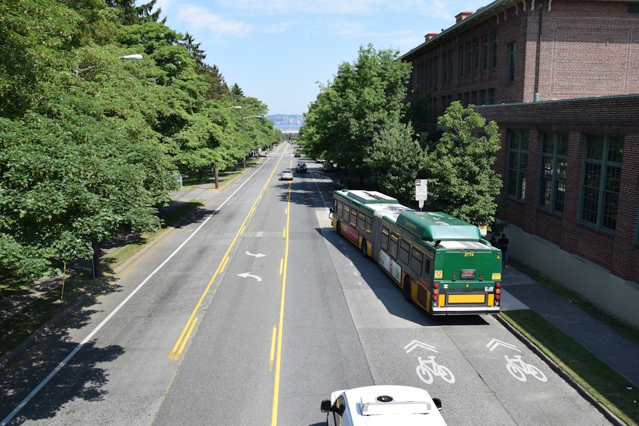 caption: A bus moves into traffic on Delridge Way in West Seattle. 