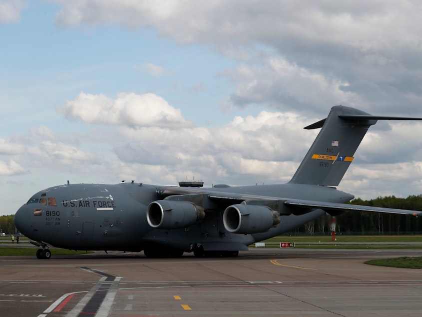 caption: A U.S. Air Force C-17 Globemaster transport plane carrying medical supplies lands in Moscow in May 2020. The same type of plane airlifted refugees from Afghanistan this past week — one of whom gave birth on the aircraft.
