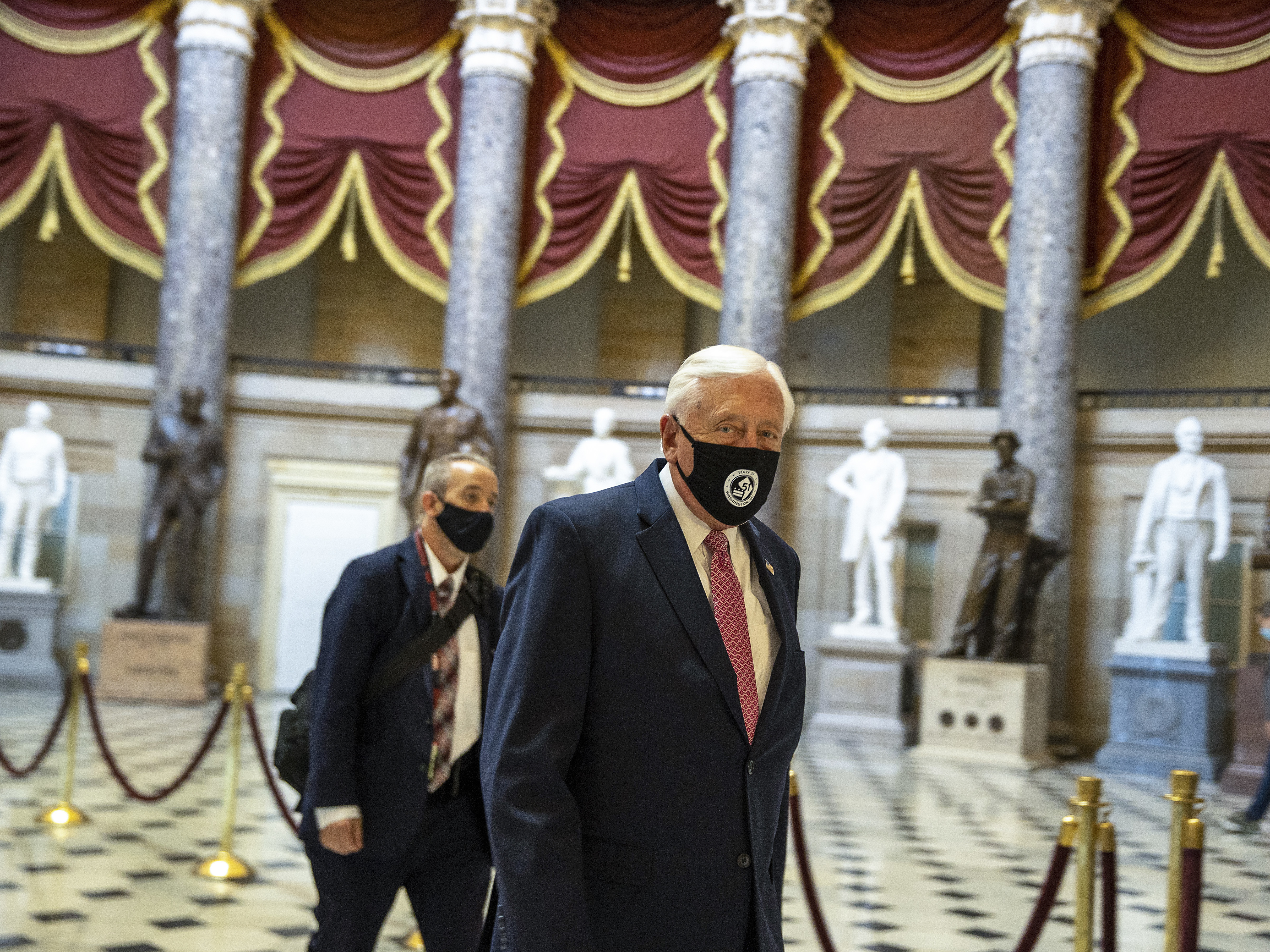 caption: House Majority Leader Rep. Steny Hoyer walks through statuary hall.