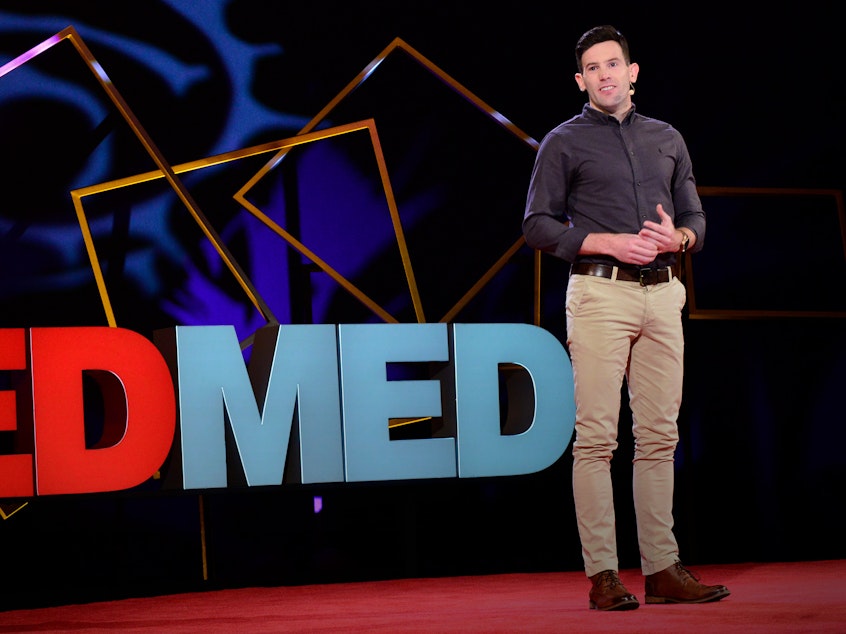 caption: Thomas Curran on the TED Stage.