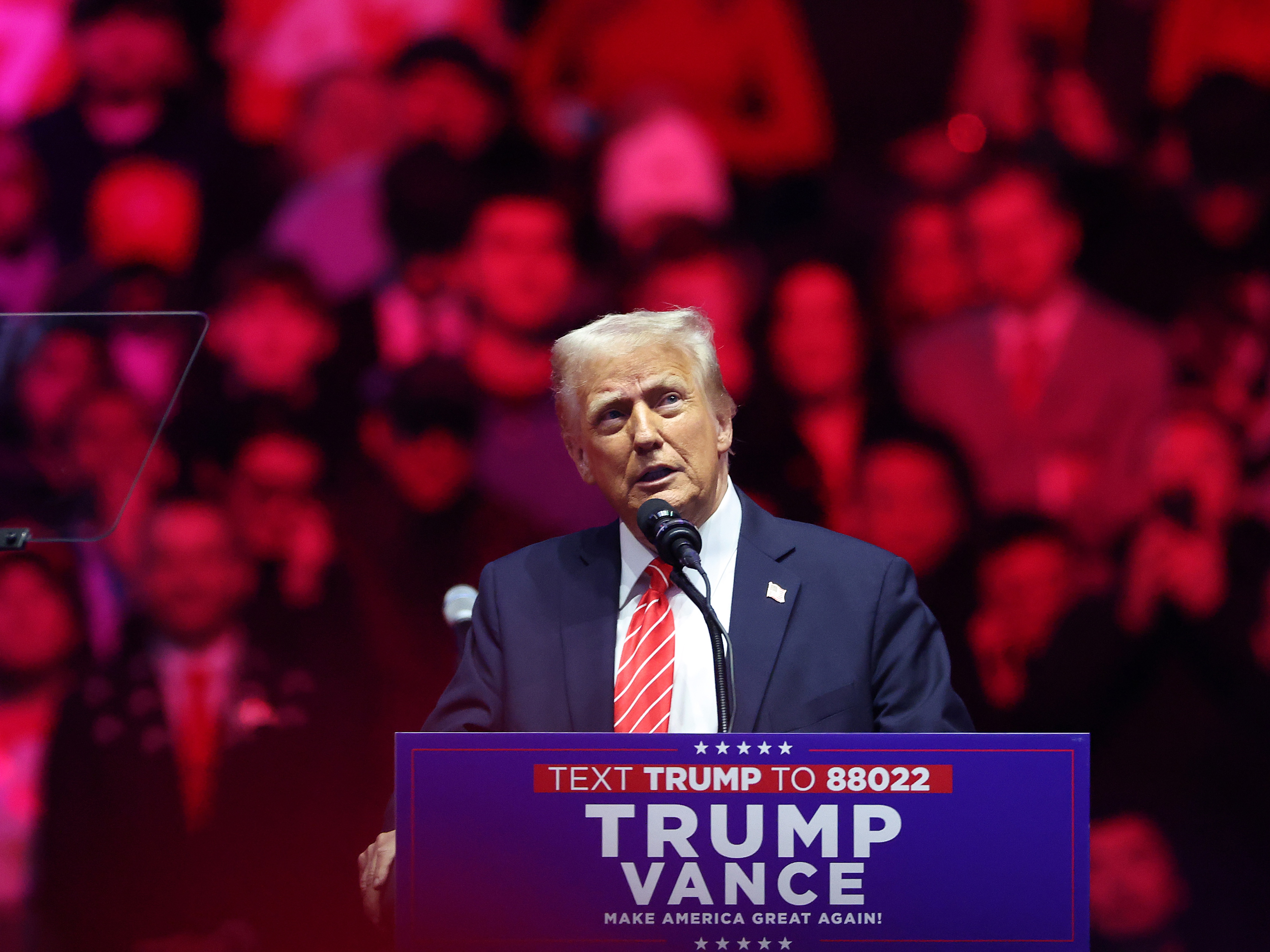 caption: Donald Trump speaks at his victory rally at the Capital One Arena on Sunday.
