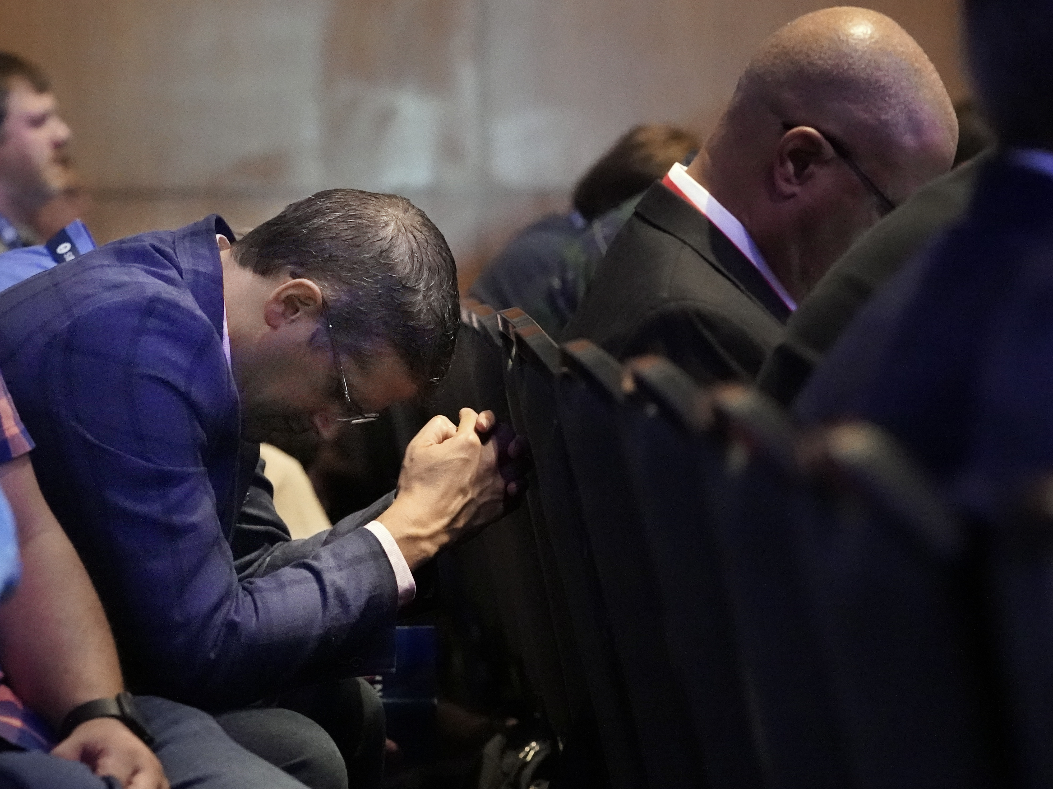 caption: A man prays during the executive committee plenary meeting at the Southern Baptist Convention's annual gathering Monday in Nashville, Tenn.
