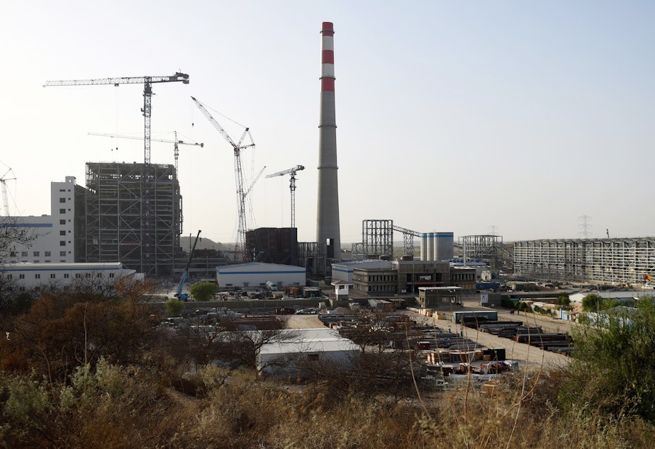 caption: A Chinese-backed power plant under construction in 2018 in the desert in the Tharparkar district of Pakistan's southern Sindh province.