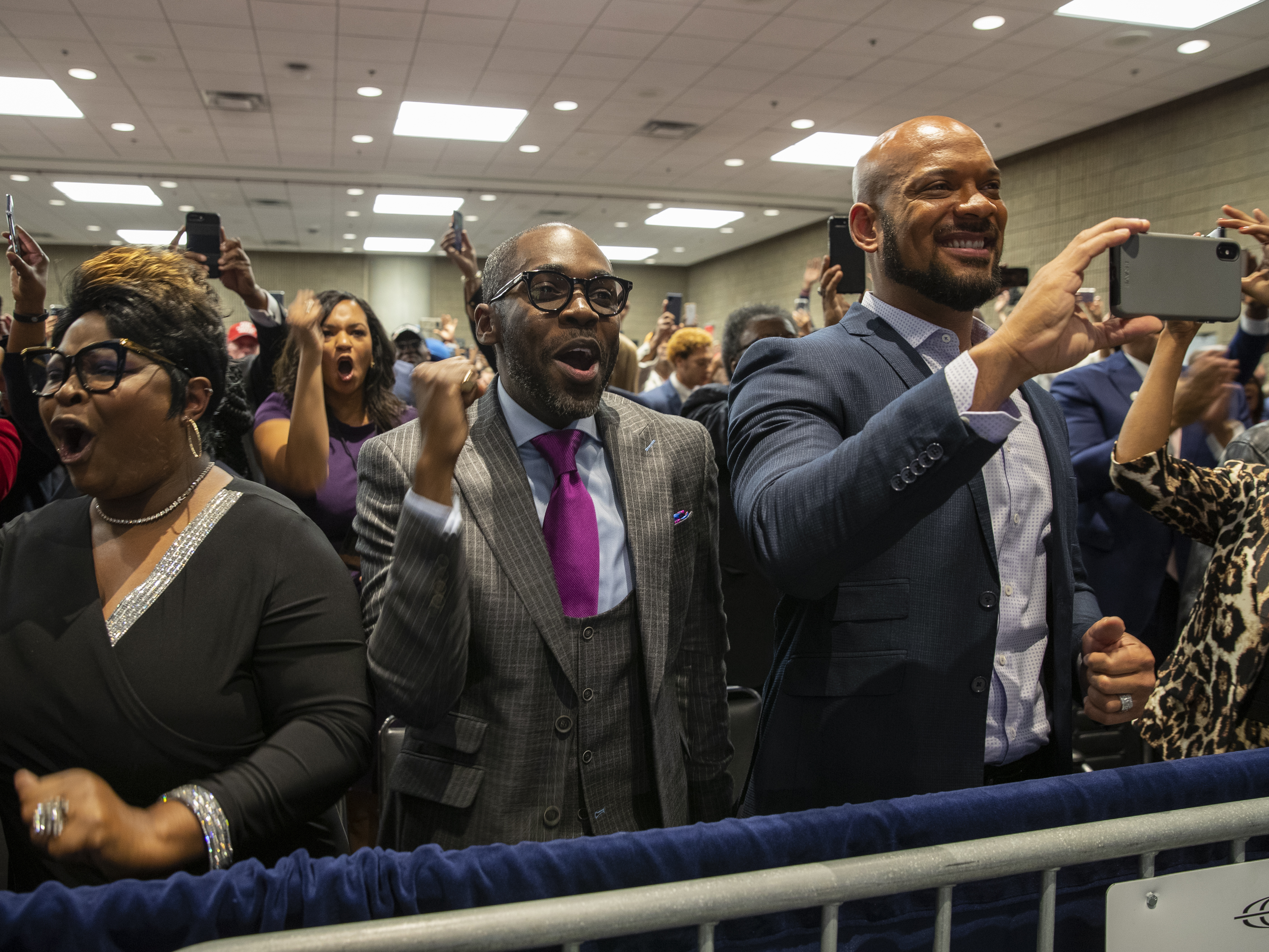 caption: Supporters of President Trump cheer as he arrives to launch Black Voices for Trump at an Atlanta event.
