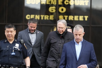 caption: Former NRA CEO Wayne LaPierre (second from right) leaves New York State Supreme Court on Wednesday. Top NRA executives for were accused of using millions in donations for private luxuries.