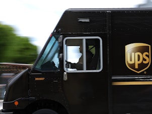 caption: UPS drivers had threatened to walk off the job unless the company provided better pay for part-time workers.