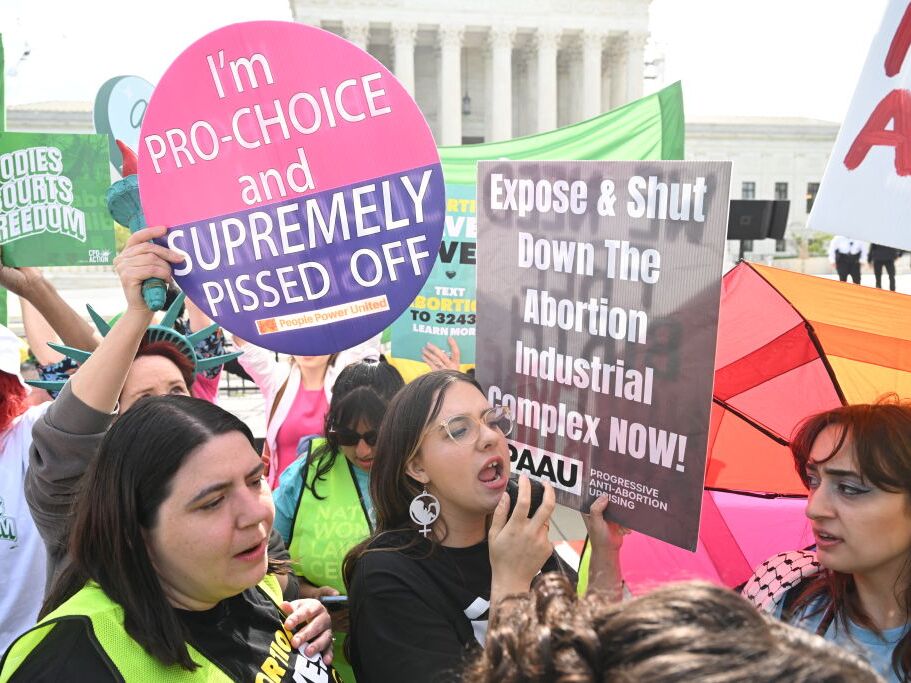 caption: Protesters rally outside the U.S. Supreme Court on April 24 as it hears arguments on whether an Idaho abortion law conflicts with the federal Emergency Medical Treatment and Labor Act.