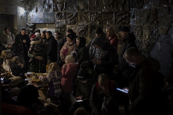 caption: <strong>March 19: </strong>People gather in a basement, used as a bomb shelter, during an air raid in Lviv, Western Ukraine.