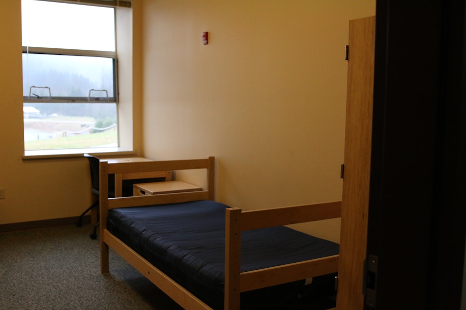 caption: One of the 20 bedrooms at the dormitory will be available for the quarantine. 