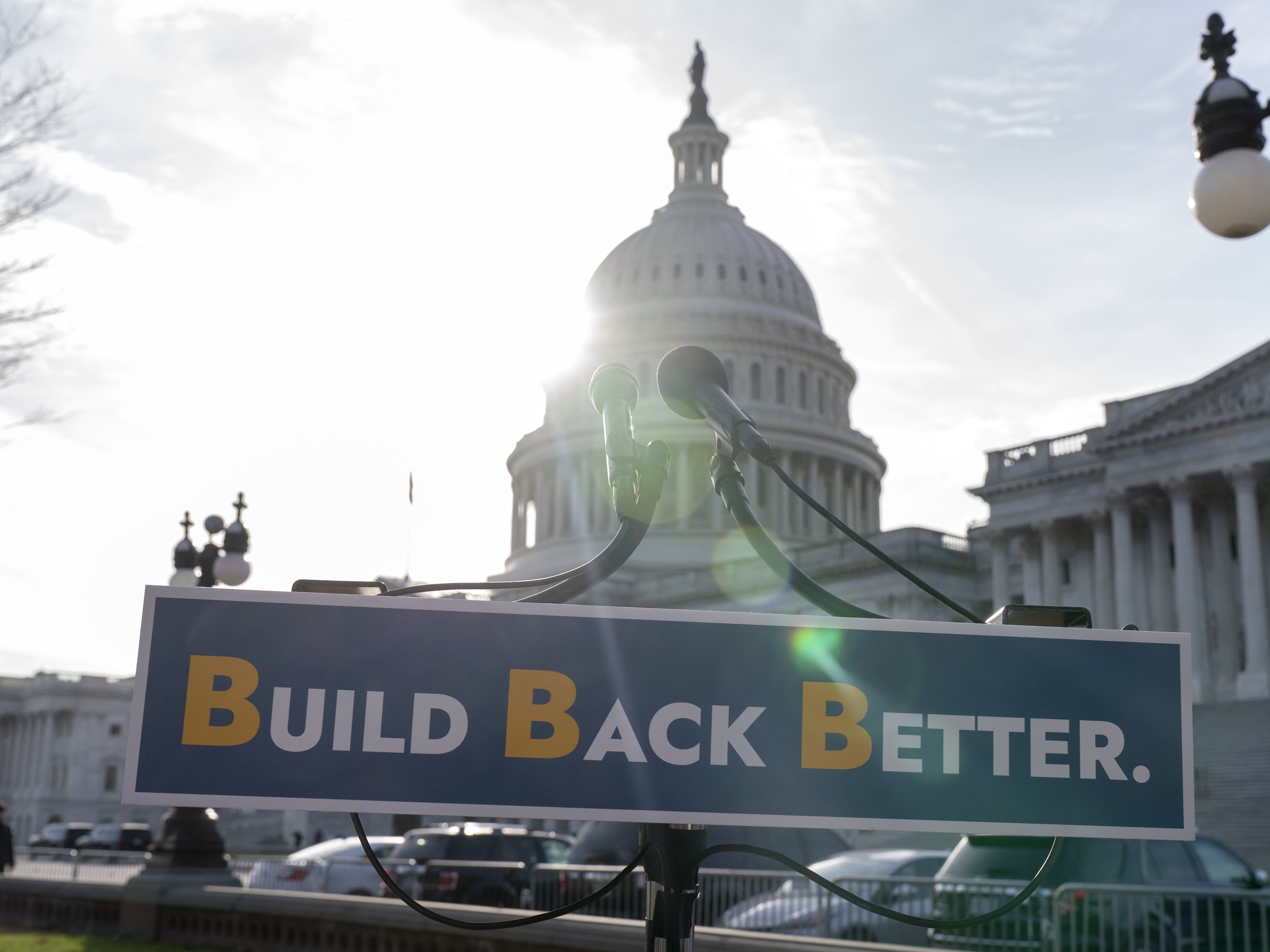caption: With the U.S. Capitol dome in the background, a sign that reads "Build Back Better" is displayed before a news conference on Dec. 15, the day the last monthly child tax credit payment was sent out.