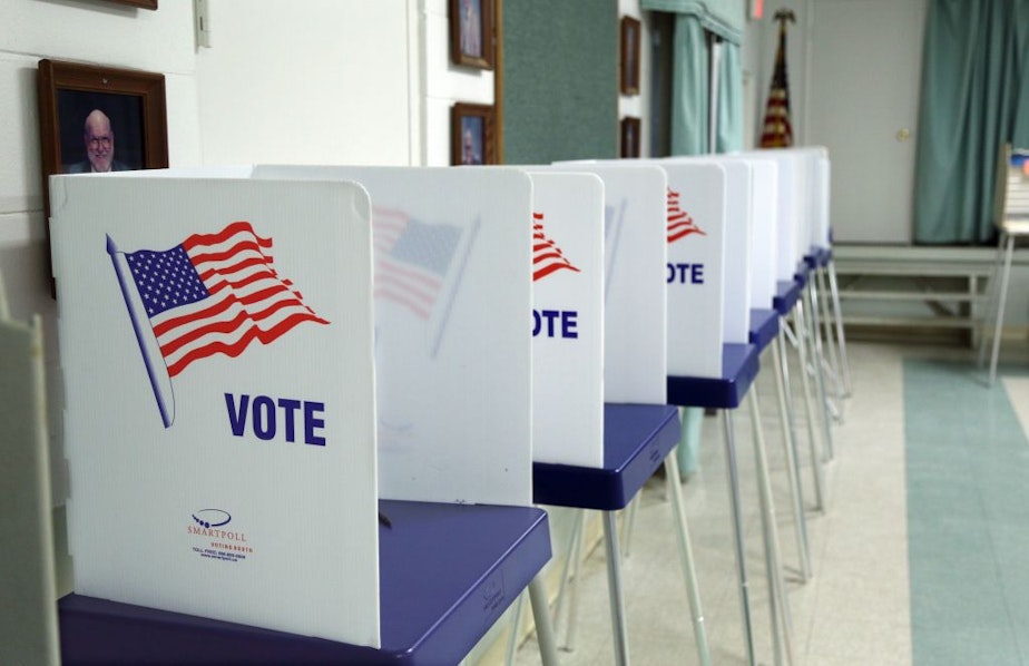 caption: Voting booths set up and ready to receive voters inside a polling station in Florida in 2016. (Gregg Newton/AFP/Getty Images)
