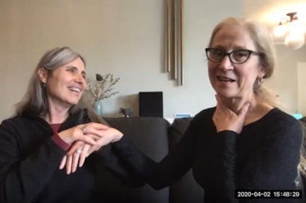 caption: Angela Theriault (at left), director of Seattle Deaf Blind Services, is deaf and almost completely blind. She communicates by touch with her interpreter (at right), Carolyn Traub. 