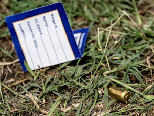 caption: A bullet casing is seen at the site of a mass shooting in the Brooklyn Homes neighborhood in Baltimore, Maryland, on Sunday. Two people were killed and 28 others were wounded during the shooting at a block party on Saturday night.