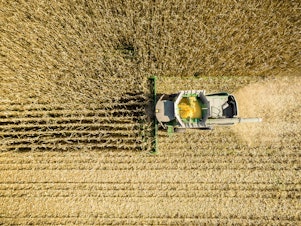 caption: An aerial view of a combine harvesting corn in a field near Jarrettsville, Md. A new study ties an estimated 4,300 premature deaths a year to the air pollution caused by corn production in the U.S.