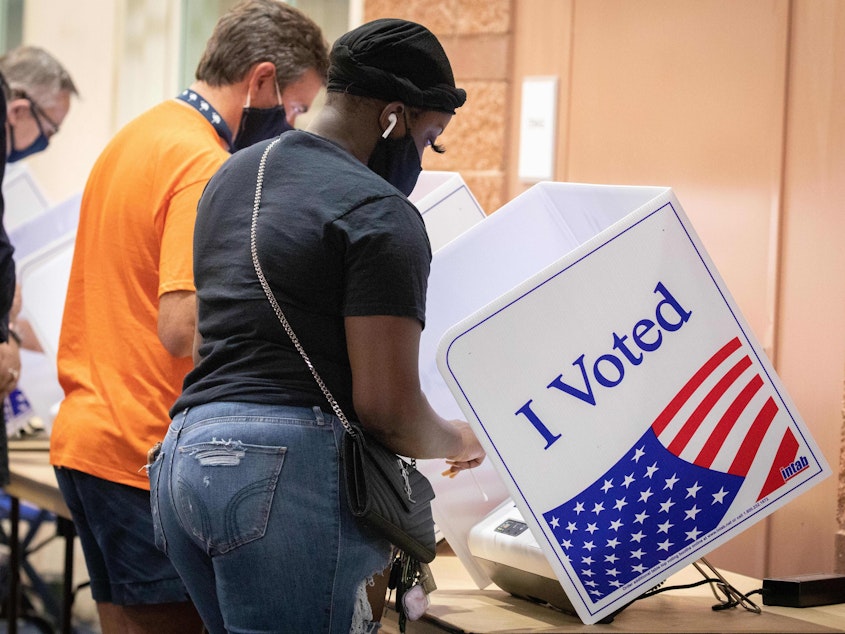 caption: Voters cast their ballots in North Charleston, S.C., on Oct. 16, 2020. A new study says the turnout gap between white and nonwhite voters in the U.S. is growing fastest<em><strong> </strong></em>in jurisdictions that were stripped of a federal voting protection by a Supreme Court decision.