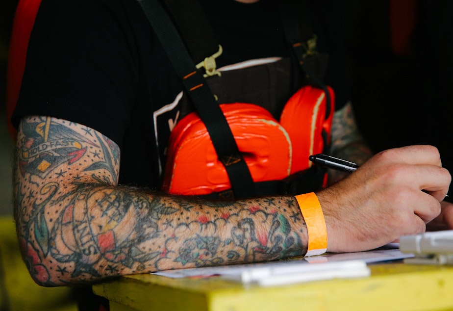 caption: Eddy Traver wears a sleeve of nautical-themed tattoos during a class at the Diver's Institute of Technology where he has been a student for the past few months, September, 15, 2021.