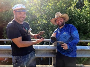 caption: Brothers Jake and Adam Cowart show off a magnet fishing haul. They are among many who picked up the hobby during the pandemic.