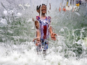 caption: A summer of extreme heat is raising alarms of health risks. Here, a child plays in a waterfall feature at Yards Park in Washington, D.C., on June 26.