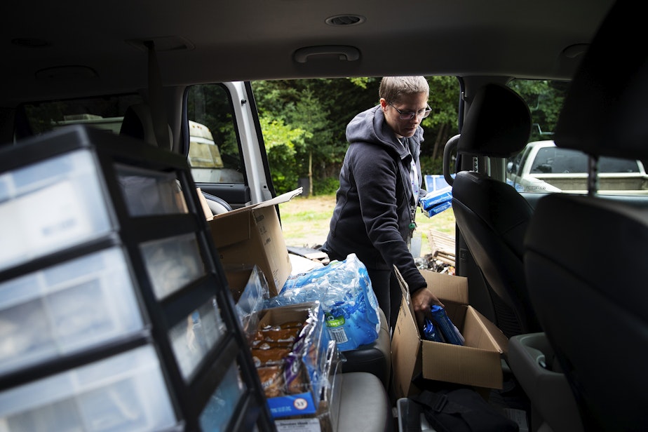 caption: Jessica Thornton, an outreach worker with Sound Pathways Syringe Services Program, delivers harm reduction supplies to individuals at their home on Tuesday, July 25, 2023, outside of Granite Falls. 