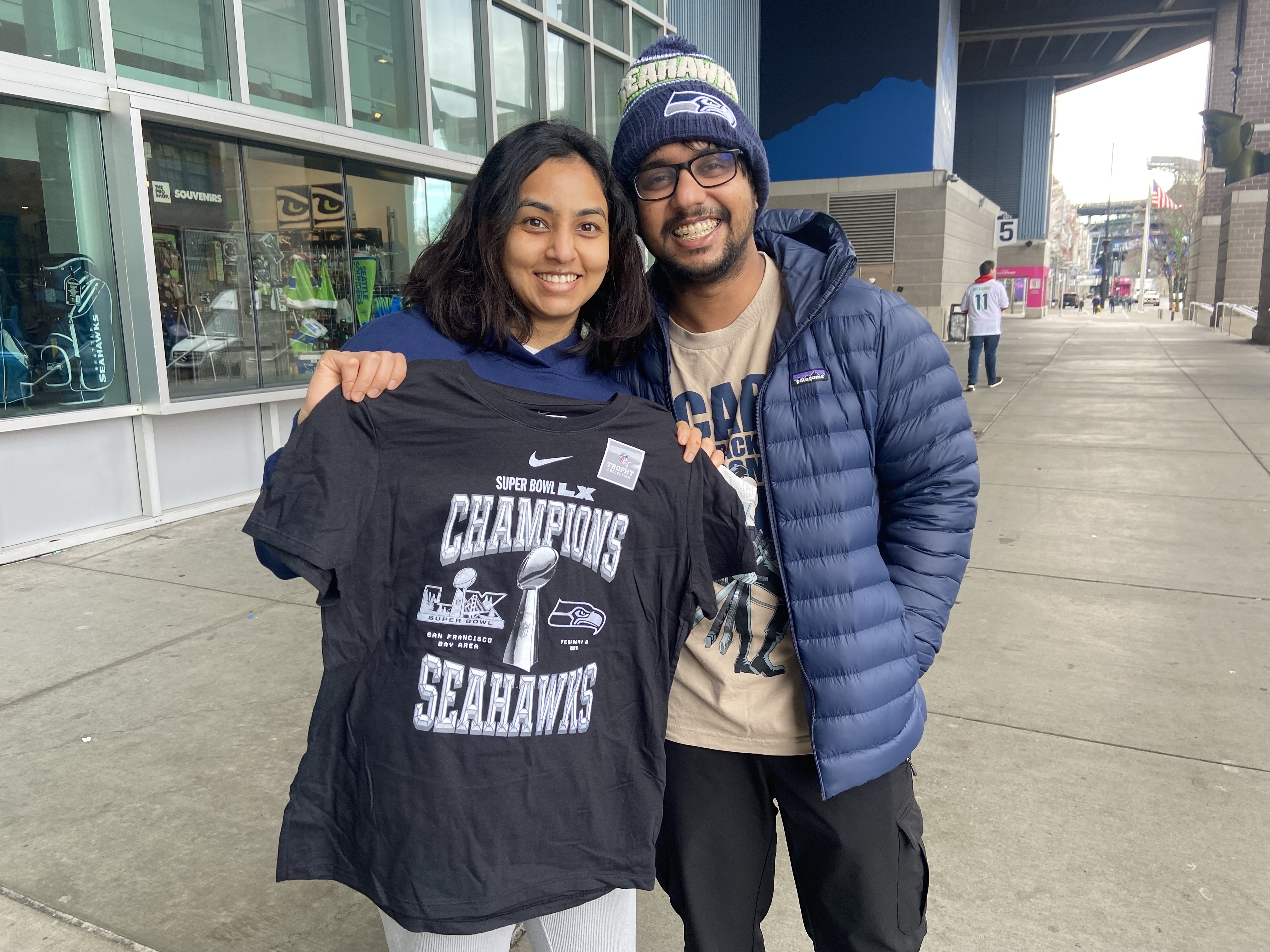 caption: AJ Venkatesh (left) and Venkat Raj (right) stopped by the Seahawks Pro Shop at Lumen Field Monday, February 9 in search of Super Bowl championship gear. 