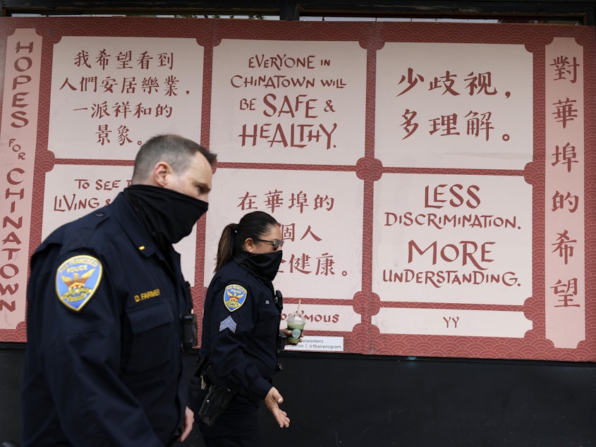 caption: San Francisco police officers patrol Chinatown on Wednesday.