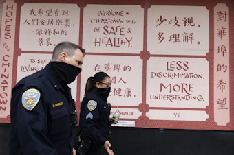 caption: San Francisco police officers patrol Chinatown on Wednesday.
