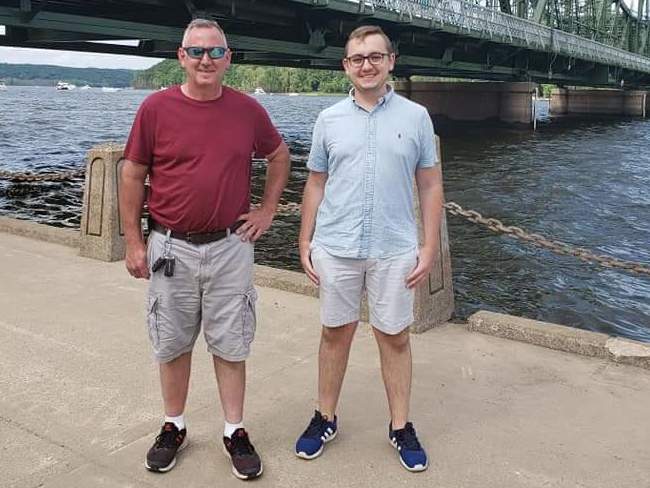 caption: Tyler Skluzacek (right) helped develop a smartwatch app to help disrupt his father Patrick's nightmares. The app recently won approval from the Food and Drug Administration.