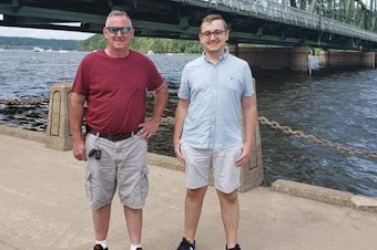 caption: Tyler Skluzacek (right) helped develop a smartwatch app to help disrupt his father Patrick's nightmares. The app recently won approval from the Food and Drug Administration.