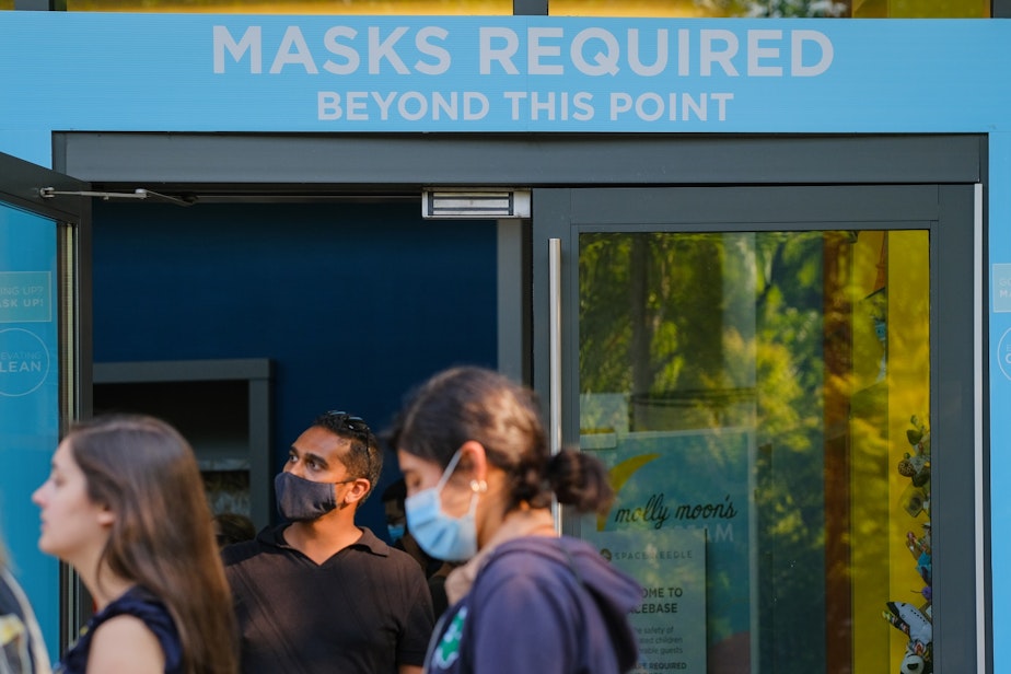 caption: Visitors roam around the Space Needle, August 2, 2021, a highly touristed attraction where masks are still required.