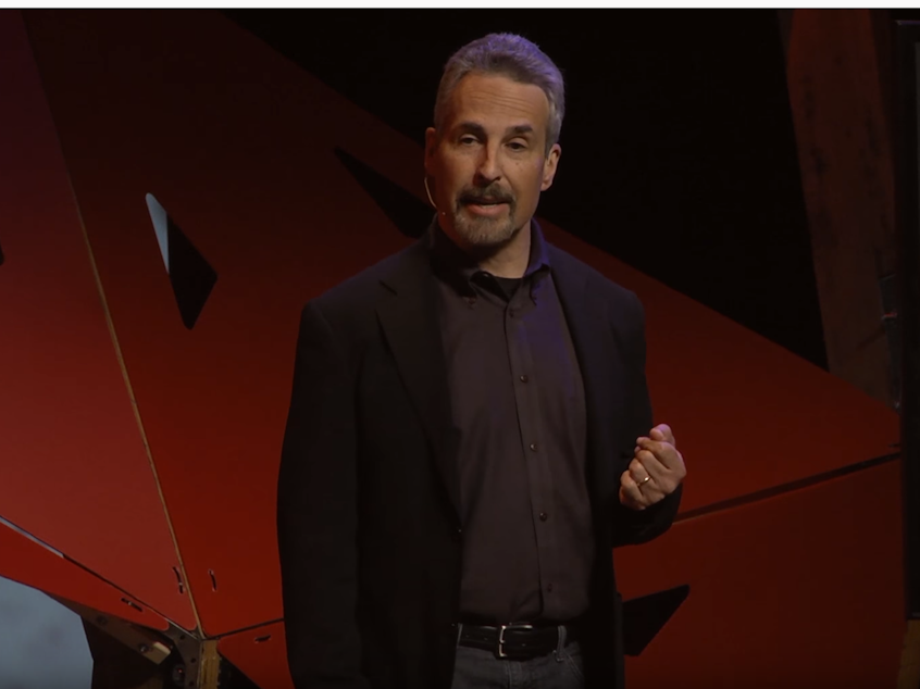 caption: Dan Moshavi on the TED stage.