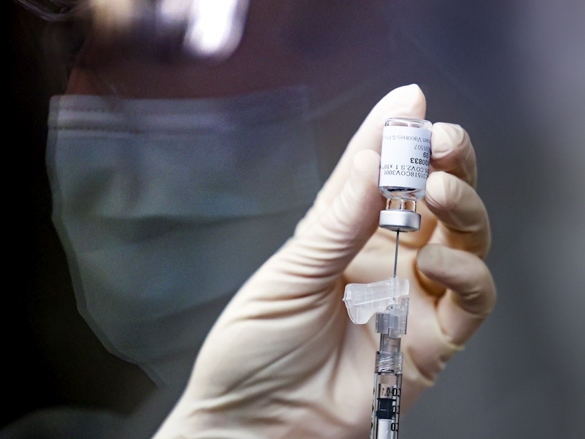 caption: Pharmacy technician Sara Berech prepared a dose of the Johnson & Johnson COVID-19 vaccine in December for a clinical trial that includes Rocky Mountain Regional VA Medical Center in Aurora, Colo.