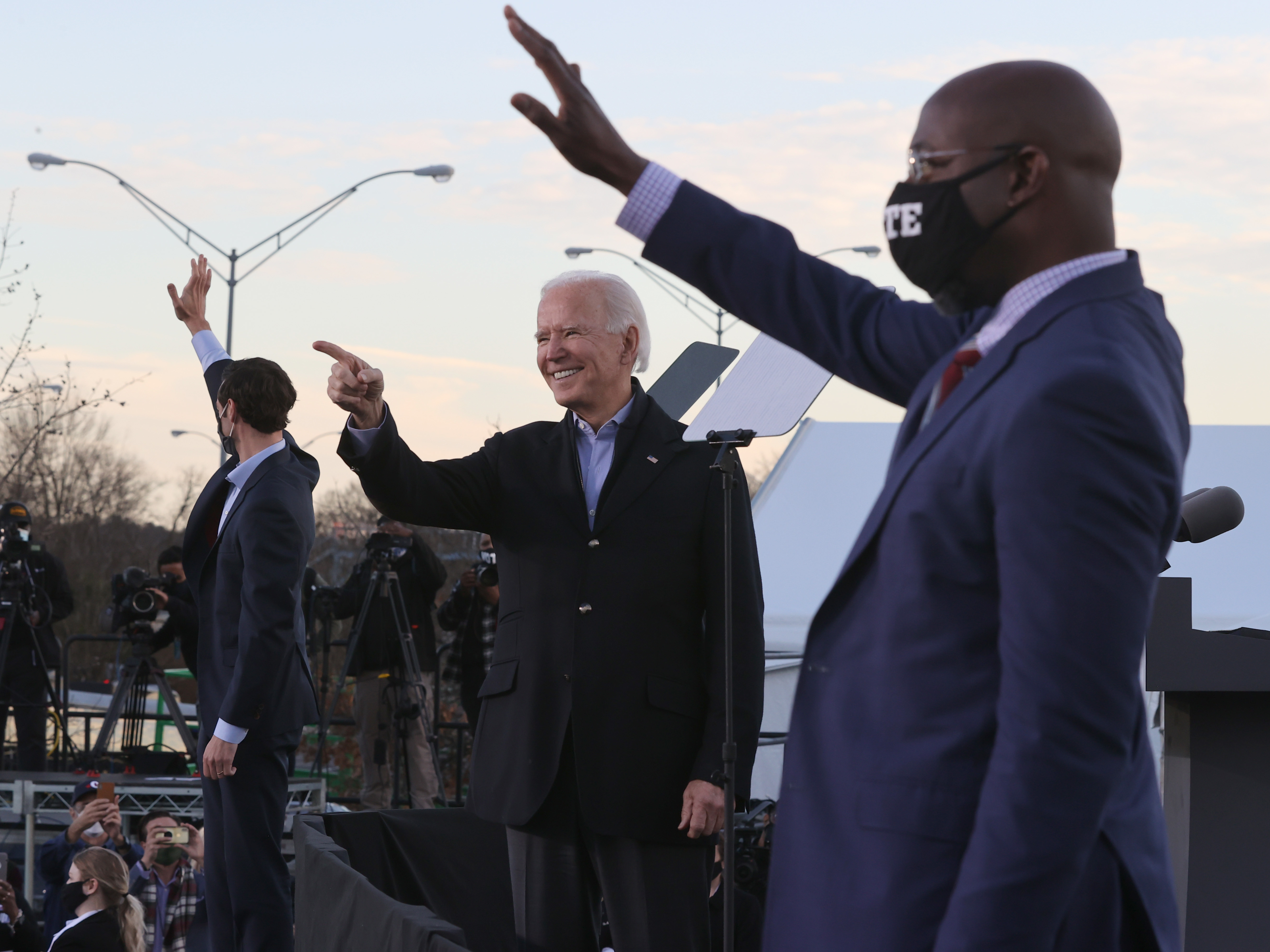 caption: President-elect Joe Biden campaigns alongside Democratic candidates for the Senate Jon Ossoff, left, and Rev. Raphael Warnock, right.