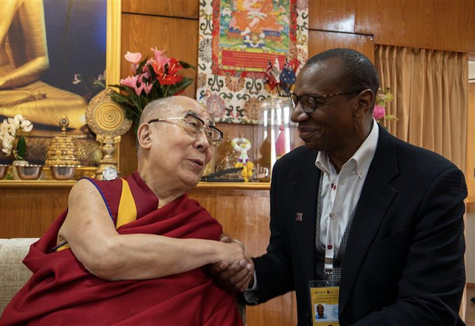 caption: Ed Taylor, vice provost and dean of Undergraduate Academic Affairs at the University of Washington, shakes the Dalai Lama's hands.