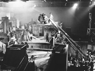 caption: Actors and other crew are shown here on the set of the movie <em>It Happened Tomorrow </em>in 1944.