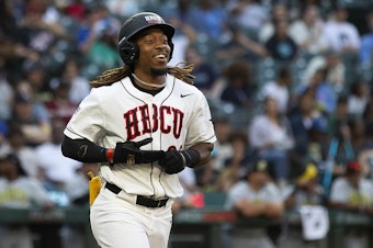caption: American League batter Corey King smiles while making his way safely to first base during the first ever HBCU Swingman Classic on Friday, July 7, 2023, at T-Mobile Park in Seattle. 